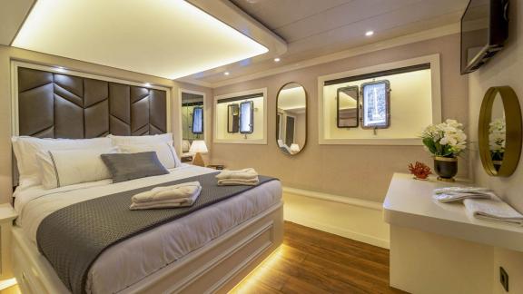 Stilvolle Gästekabine mit luxuriösem Doppelbett auf der Segelyacht Queen of Makri, ideal für komfortable Nächte.