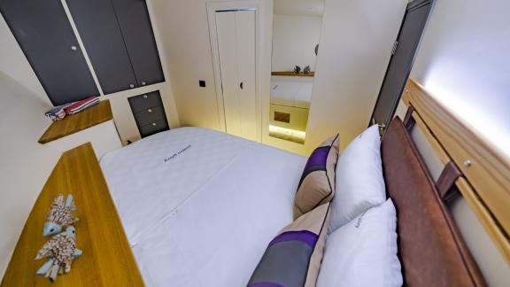 Cabin with comfortable double bed and ample storage on Gulet Golden Glory.