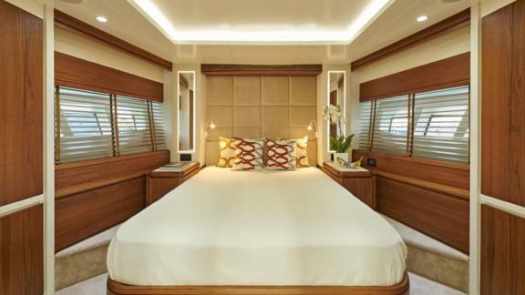 Luxurious master cabin with large windows and stylish wood accents on motor yacht La Fenice.