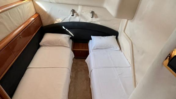 Twin bedroom on motor yacht Sky 22 stands out with its comfortable beds and stylish design.