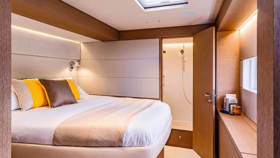 Cozy cabin with double bed, en-suite bathroom, and stylish decor on the catamaran Amada Mia