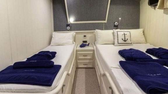 Double cabin of the sailing yacht The Blue Sea with two single beds.