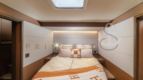 Comfortable double cabin with luxurious Hermès design and natural light aboard a Princess S Yacht