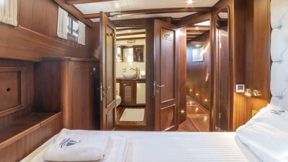 Cabin of the gulet yacht Jasemin 1 with a view of the bathroom and stylish wooden furnishings.