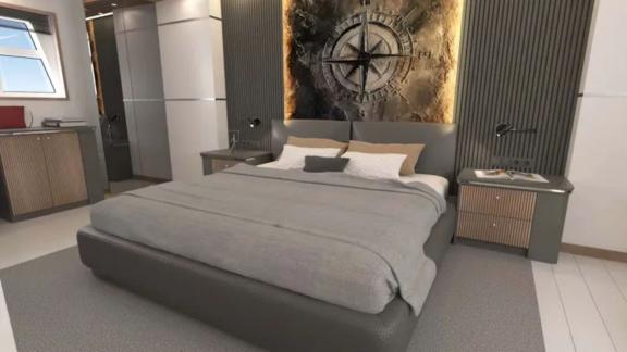 The master cabin of trawler Lavin features a modern bedroom with elegant wall decor and a large bed.