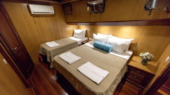 Comfortable cabin with double bed and single bed.