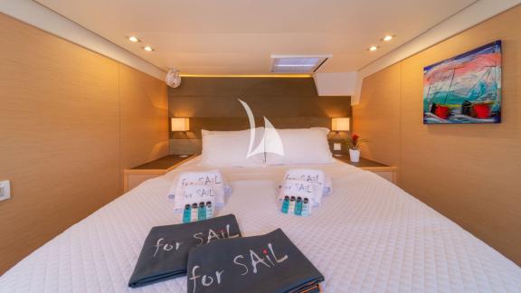 Luxurious double bed with white linens and