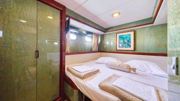 The double bedroom on motor yacht Custom Blanka offers a comfortable resting area.