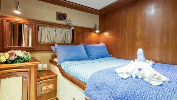 Intimate cabin with double bed on a Gulet in Fethiye, perfect for romantic nights at sea.