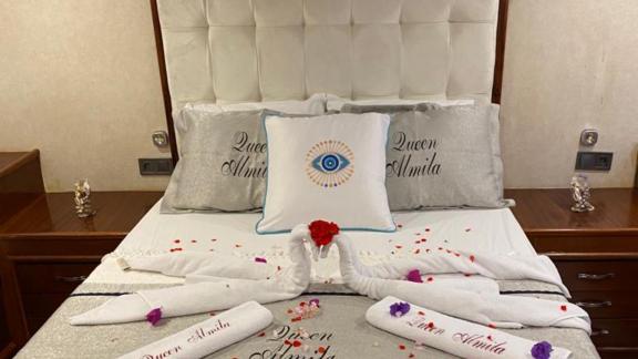 Lovingly decorated cabin on the Queen Almila gulet with towel art and luxurious bedding.