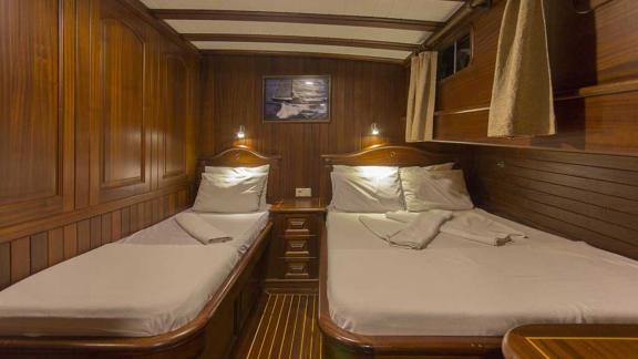 Double cabin with one double bed and one single bed.