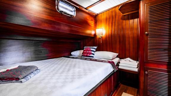 Comfortable cabin with double bed and elegant lighting on Gulet Golden Joy in Bodrum.