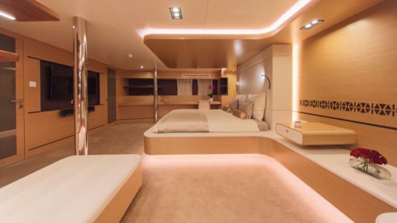 Modern bedroom on Omnia with a large bed and stylish lighting.