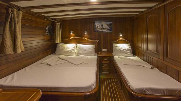 Double cabin with one large bed and one single bed.