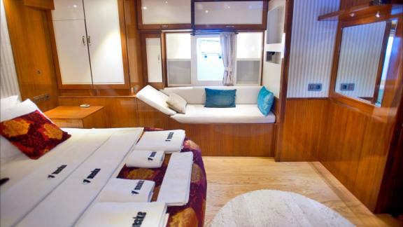 The master cabin of Maske 2 offers a comfortable bed, stylish seating areas, and ample storage space.