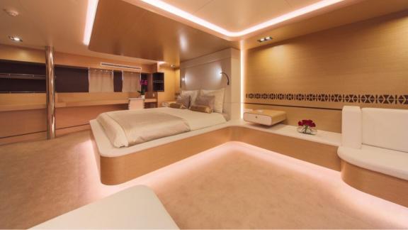 Stylish bedroom on Omnia with a large bed and bright lighting.