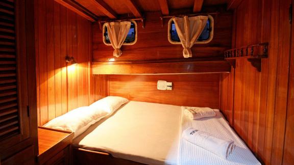 The double cabin on Gulet Tufan 5 offers a warm ambiance with elegant wood interior and soft lighting.