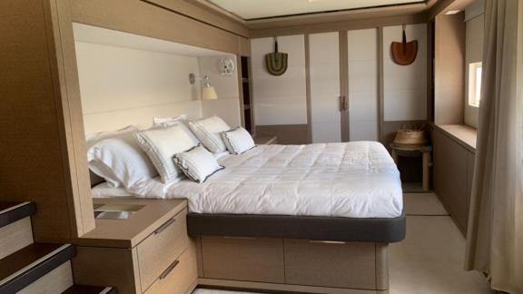 Tastefully decorated bedroom featuring a large double bed and built-in wardrobes.