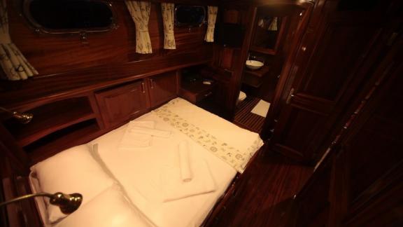 Cozy cabin of the Gulet Doris with a double bed and private bathroom.