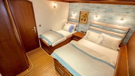 Two-bed cabin with maritime décor on the Gulet Freedom in Marmaris, ideal for a comfortable stay.