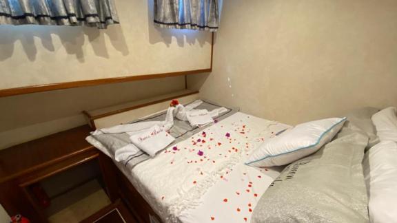 Tastefully decorated cabin on the Queen Almila gulet with rose petals and towel art.