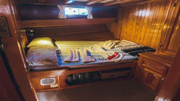 Single cabin with wooden walls and single bed. Perfect for quiet and restful nights at sea.