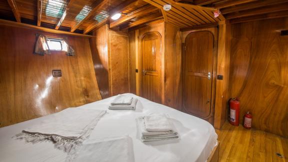 Spacious cabin of Gulet Valerie with wooden paneling.