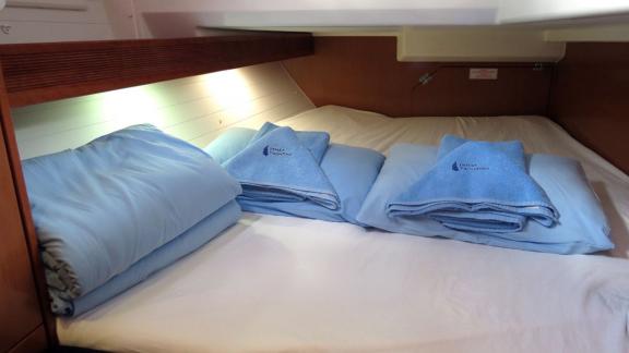 The double cabin of sailing yacht Almina is furnished with a comfortable bed and pillows.