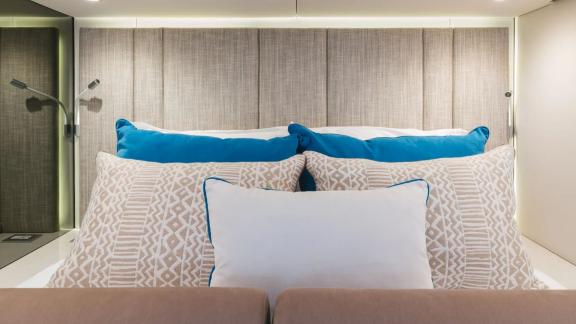 In Kastela Zara’s cabin bed features patterned pillows soft lighting and reading lamps.