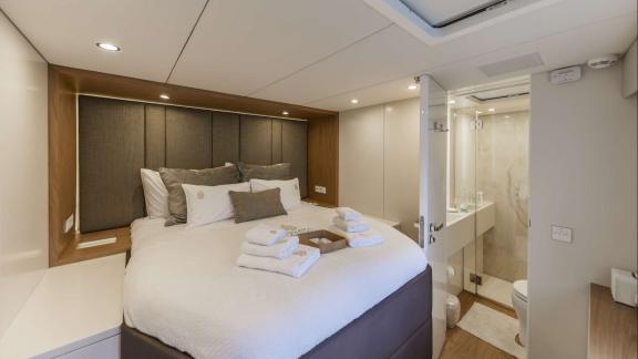 This Sunreef 60 Sinata cabin offers cozy style, bright space, and a private en-suite bathroom.