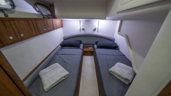 The guest cabin of Karan motor yacht with twin beds offers comfortable accommodation.