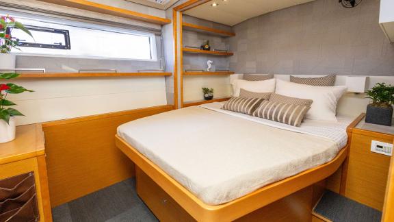 Modernly furnished guest cabin with a double bed and stylish decor on the King of Diamonds.