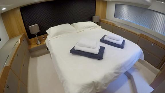 The spacious bedroom of the Get Lucky motor yacht offers comfortable accommodation.