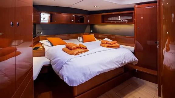 The spacious and comfortable cabin of the Tourbillon yacht features stylish orange accents.