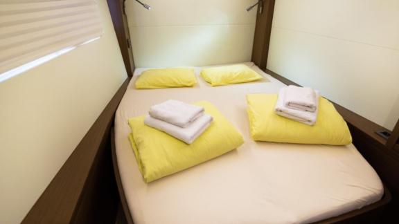 The cozy cabin of the Lagoon 50 features a double bed, fresh linens, and soft lighting for restful nights.