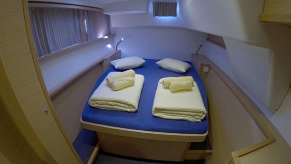 Spacious double cabin in the Saelma Lagoon 450 with soft towels and bedding, ideal for two people.