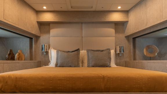 The spacious bedroom of motor yacht La Romana offers a peaceful atmosphere with a simple and elegant design.