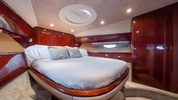 The VIP cabin of the yacht Make My Day stands out with its comfortable bed and modern design.