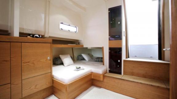 The motor yacht Celebrate features a bright cabin with a large bed.