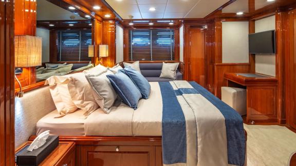 The main cabin of Divine yacht offers an elegant bed and cozy seating area.