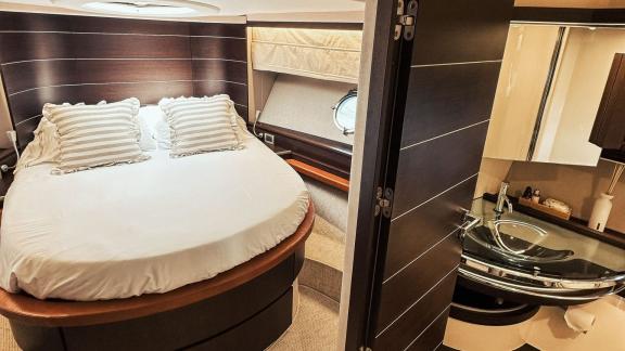 The bedroom on motor yacht Esperanza offers a cozy sleeping area and an adjoining private bathroom for a comfortable sta