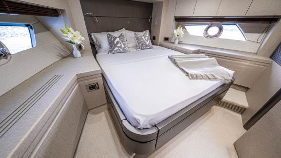 The elegant master cabin of the Outlaw yacht features a comfortable bed and modern details. Ideal for yacht tours in Dub