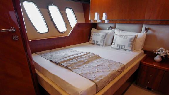 The double bedroom of the Notorious motor yacht makes your Dubai yacht rental experience luxurious and comfortable.