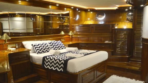 The cabin of Queen Atlantis stands out with stylish wooden design and modern bed decor.