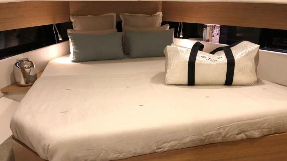 Modern and cozy bedroom of the Bambino motor yacht available for rent in Ibiza.