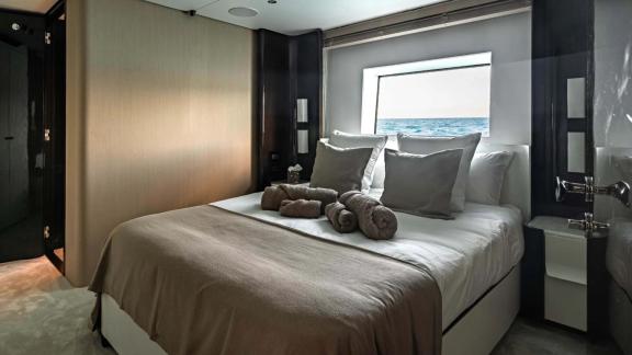Comfortable sea view cabin on Nemesis yacht with modern design and cozy bed.