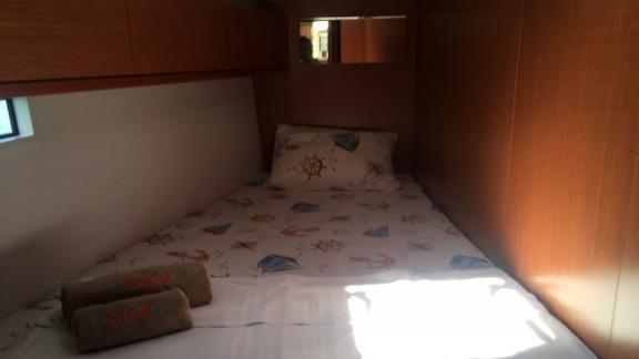 Single cabin on the sailing yacht Santiago with maritime-themed bedding.