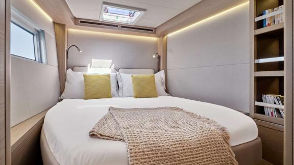 Eldamar’s guest cabin features soft lighting and a peaceful bed space with books for a quiet escape.
