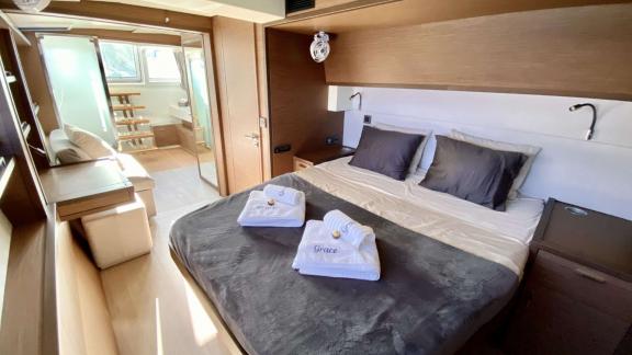 Grace Lagoon 620 catamaran master cabin offers bed and cozy sitting area.