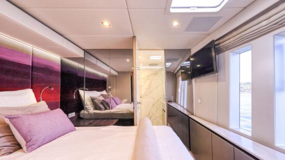 With large windows and sleek finishes, this guest suite aboard Honeybird offers a luxurious charter stay near Šibenik.